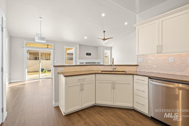 4672 N Patimos Ave, Meridian, ID 83646 - kitchen featuring stainless steel dishwasher, a sink, tasteful backsplash, dark wood-style flooring, and recessed lighting