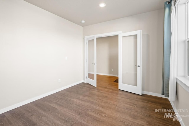 4672 N Patimos Ave, Meridian, ID 83646 - unfurnished bedroom featuring french doors, dark wood finished floors, baseboards, and recessed lighting
