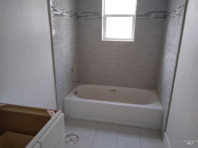 bathroom featuring tiled shower / bath combo and tile patterned floors