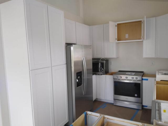 kitchen with white cabinets and appliances with stainless steel finishes