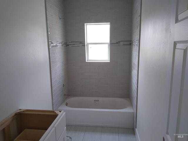 bathroom featuring tile patterned floors, vanity, and tiled shower / bath