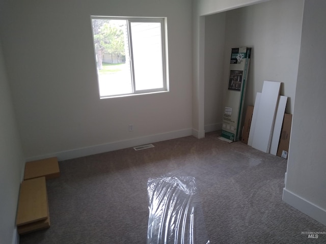 unfurnished bedroom featuring dark carpet