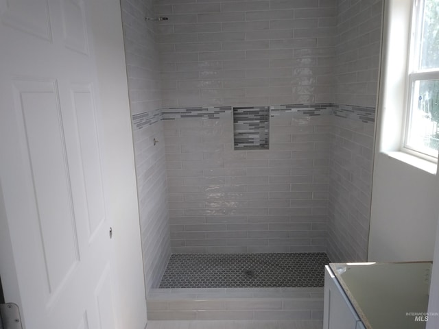 bathroom with a tile shower