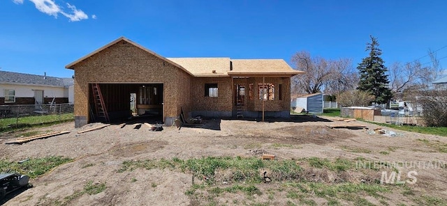 back of house with an outbuilding and a garage