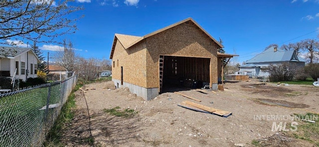 exterior space with a garage and an outdoor structure