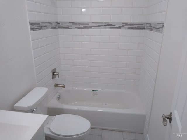 full bathroom with vanity, tiled shower / bath combo, and toilet