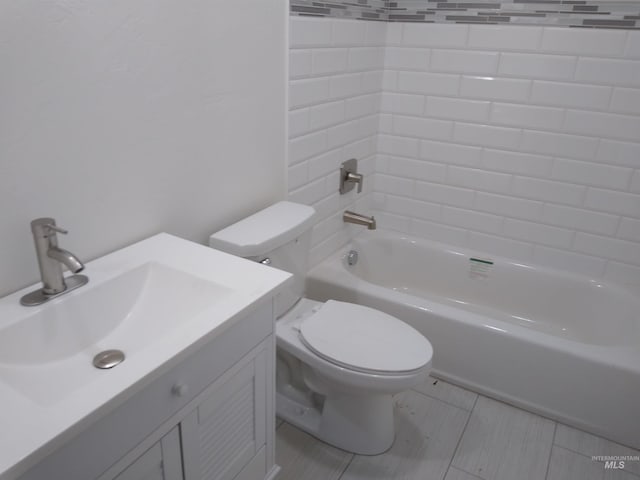 full bathroom with tile patterned floors, vanity, toilet, and tiled shower / bath