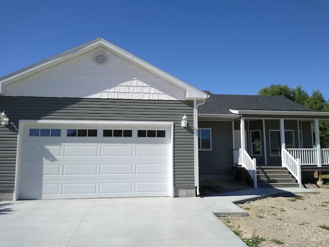 view of front facade featuring a porch and a garage