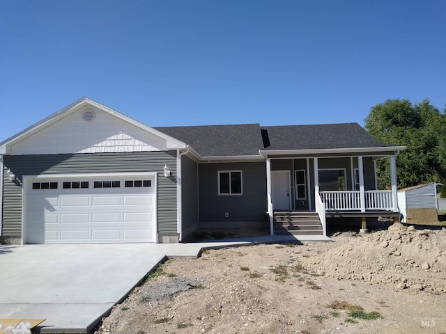 single story home featuring a porch and a garage