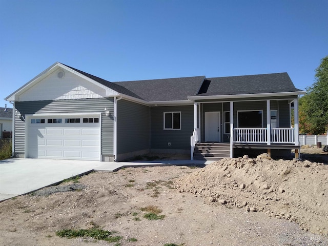 single story home featuring a porch and a garage