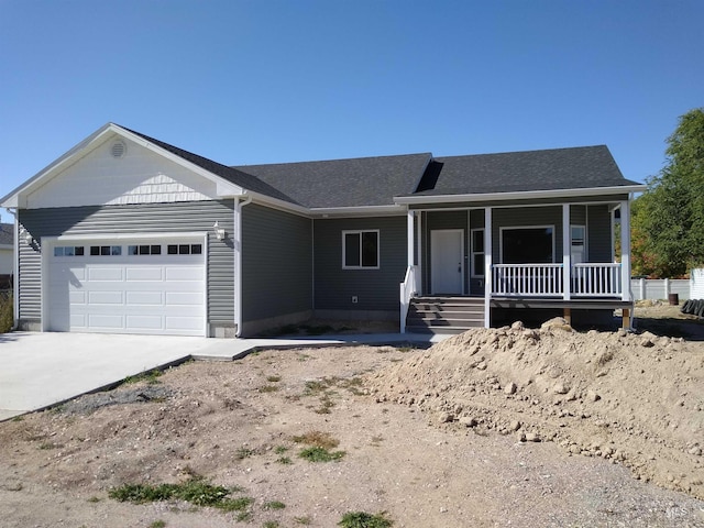 single story home featuring covered porch and a garage