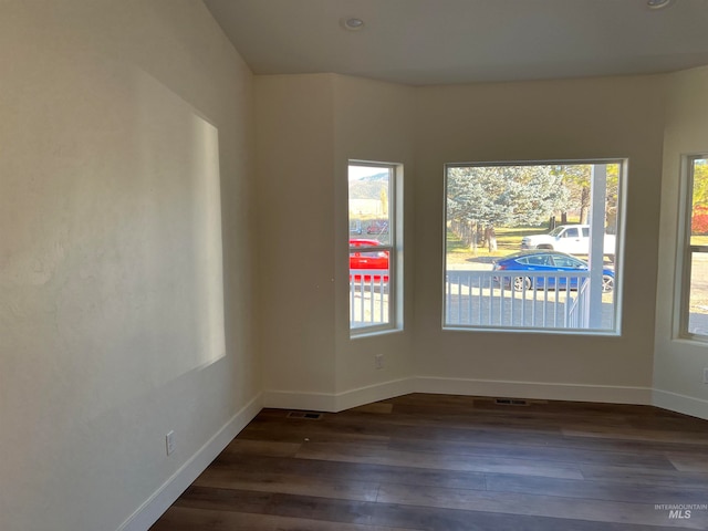 spare room with dark hardwood / wood-style flooring