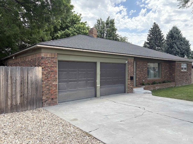 1715 S 10th Ave, Caldwell, ID 83605 - view of front of property with an attached garage, concrete driveway, brick siding, and a chimney