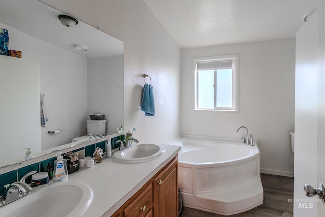 3537 Brogan Rd, Emmett, ID 83617 - full bath featuring toilet, a bath, wood finished floors, and double vanity