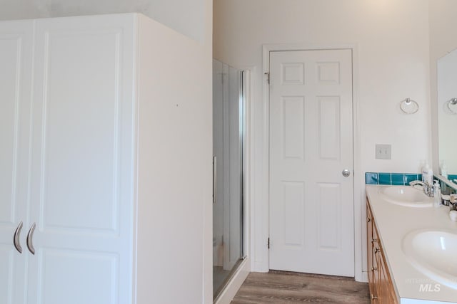 3537 Brogan Rd, Emmett, ID 83617 - full bath featuring a stall shower, double vanity, and wood finished floors
