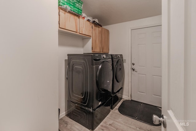 3537 Brogan Rd, Emmett, ID 83617 - laundry room featuring washer and clothes dryer, wood finished floors, cabinet space, and baseboards