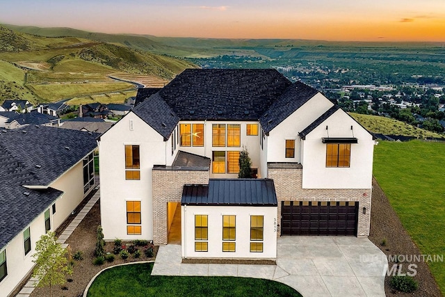 exterior space with a garage and a lawn