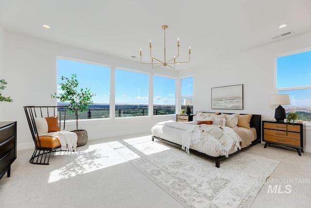 bedroom featuring a chandelier and light colored carpet