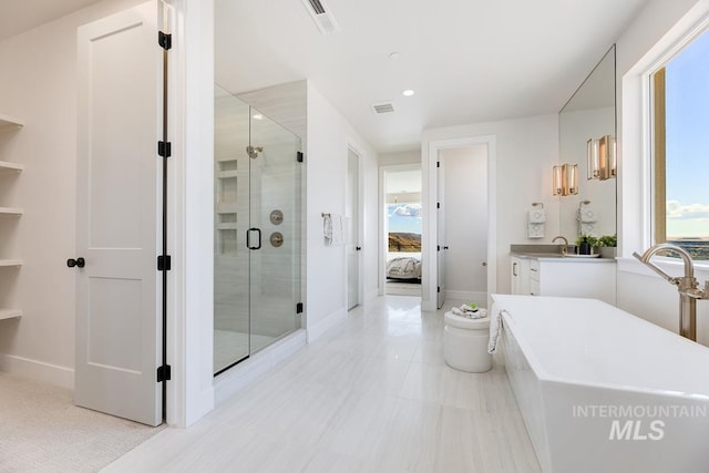 bathroom featuring tile patterned flooring, vanity, and separate shower and tub