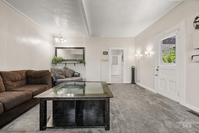 1406 Libby St, Clarkston, WA 99403 - carpeted living area featuring a chandelier, baseboards, and a textured ceiling