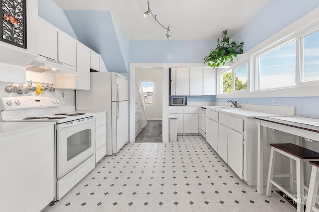 1406 Libby St, Clarkston, WA 99403 - kitchen with white appliances, under cabinet range hood, white cabinets, a sink, and light floors