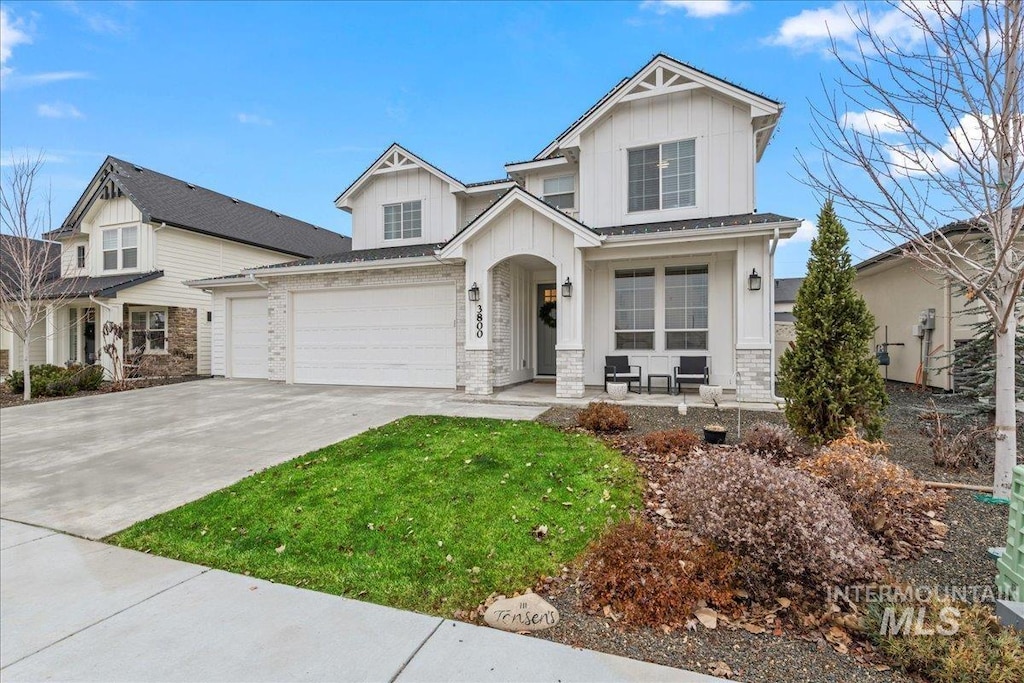 view of front of property featuring a garage and a front lawn