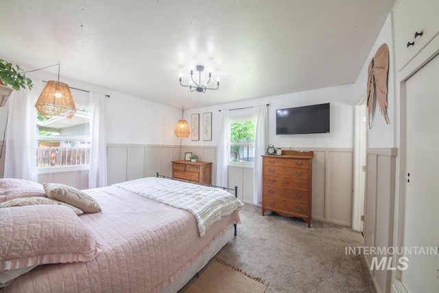3509 8th St Unit C, Lewiston, ID 83501 - carpeted bedroom with a wainscoted wall and a chandelier