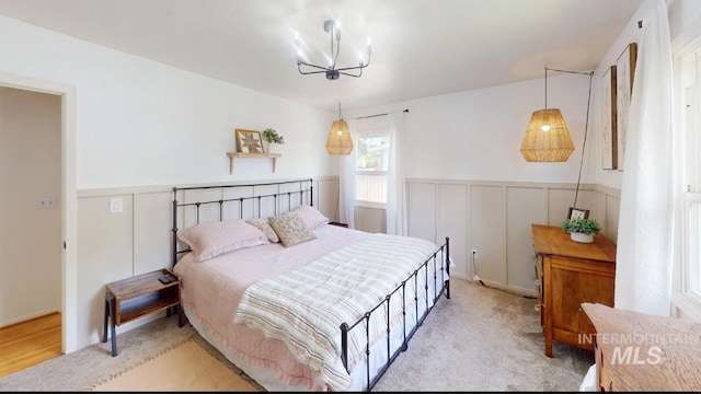 3509 8th St Unit C, Lewiston, ID 83501 - bedroom with wainscoting and a chandelier