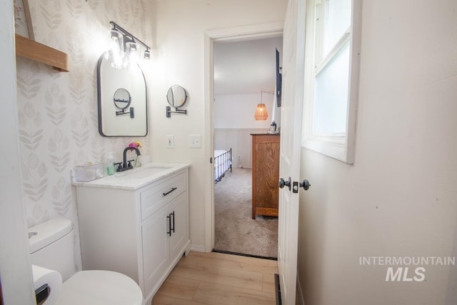 3509 8th St Unit C, Lewiston, ID 83501 - bathroom with vanity, wood finished floors, toilet, and wallpapered walls