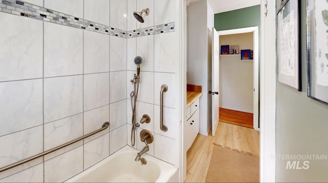 3509 8th St Unit C, Lewiston, ID 83501 - bathroom with washtub / shower combination, wood finished floors, and vanity