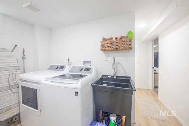 3509 8th St Unit C, Lewiston, ID 83501 - washroom with washing machine and dryer and light wood-type flooring