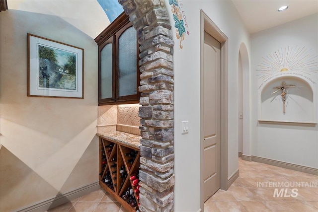 215 W Riverbridge Ln, Eagle, ID 83616 - wine cellar with light tile patterned flooring, recessed lighting, and arched walkways