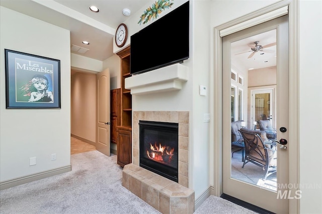 215 W Riverbridge Ln, Eagle, ID 83616 - living room featuring carpet floors, a tiled fireplace, recessed lighting, and a ceiling fan