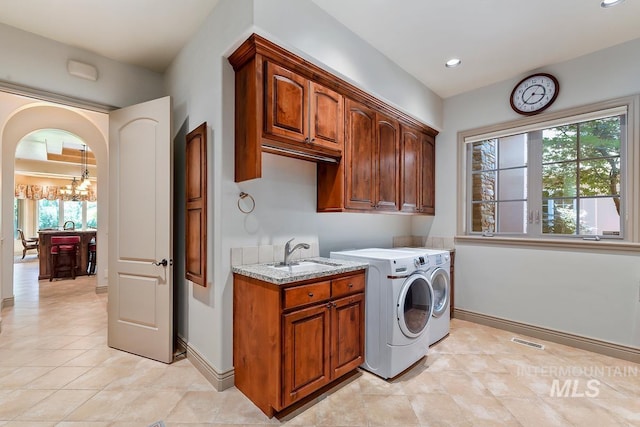 215 W Riverbridge Ln, Eagle, ID 83616 - laundry area featuring independent washer and dryer, cabinet space, plenty of natural light, light tile patterned flooring, and recessed lighting