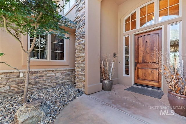 215 W Riverbridge Ln, Eagle, ID 83616 - entrance to property with stone siding and stucco siding