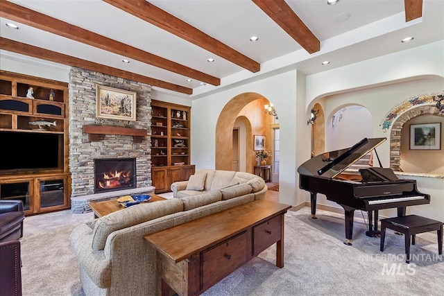 215 W Riverbridge Ln, Eagle, ID 83616 - carpeted living room with beamed ceiling, arched walkways, recessed lighting, a stone fireplace, and built in features