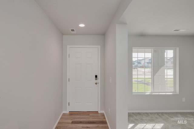 entryway with visible vents, baseboards, and wood finished floors