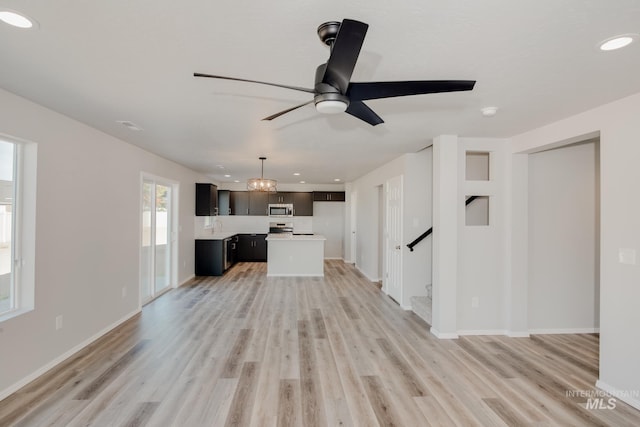 unfurnished living room featuring light wood-style flooring, a ceiling fan, recessed lighting, and baseboards