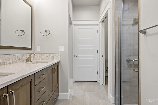 bathroom with vanity, tile patterned floors, and a shower with door