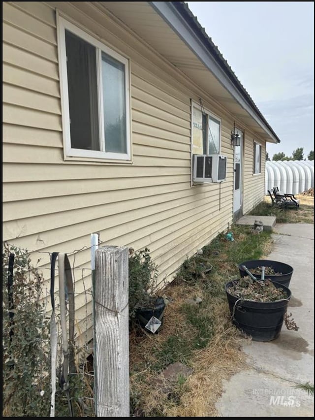 view of side of property with cooling unit