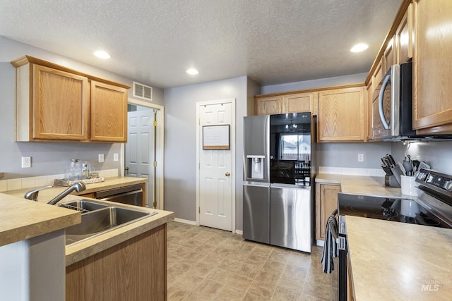 kitchen with recessed lighting, stainless steel appliances, a sink, visible vents, and light countertops