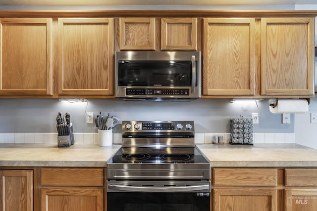 kitchen featuring stainless steel appliances and light countertops