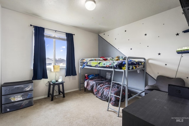 bedroom featuring a textured ceiling, carpet, and baseboards