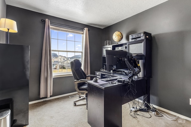 carpeted home office featuring a textured ceiling, visible vents, and baseboards