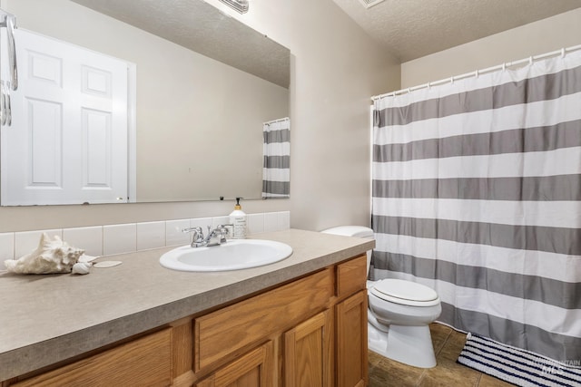 bathroom featuring a shower with shower curtain, toilet, tile patterned floors, a textured ceiling, and vanity