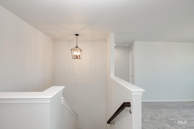 stairs with carpet floors, baseboards, and a chandelier