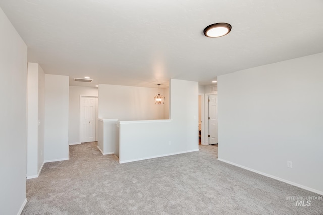 spare room featuring recessed lighting, baseboards, visible vents, and light colored carpet