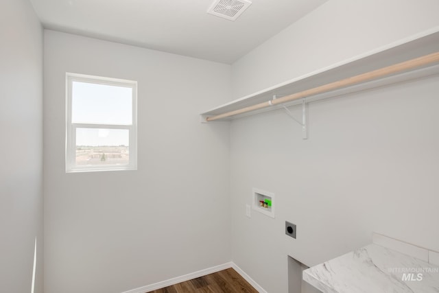 clothes washing area featuring dark wood finished floors, hookup for a washing machine, visible vents, electric dryer hookup, and laundry area