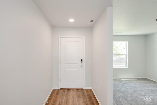 entryway featuring light wood-type flooring, visible vents, and baseboards