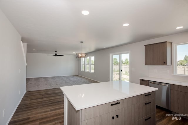 kitchen featuring open floor plan, light countertops, backsplash, a center island, and dishwasher